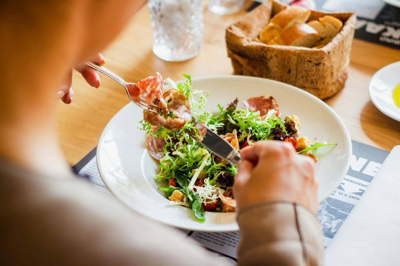 A person eating at a restaurant.